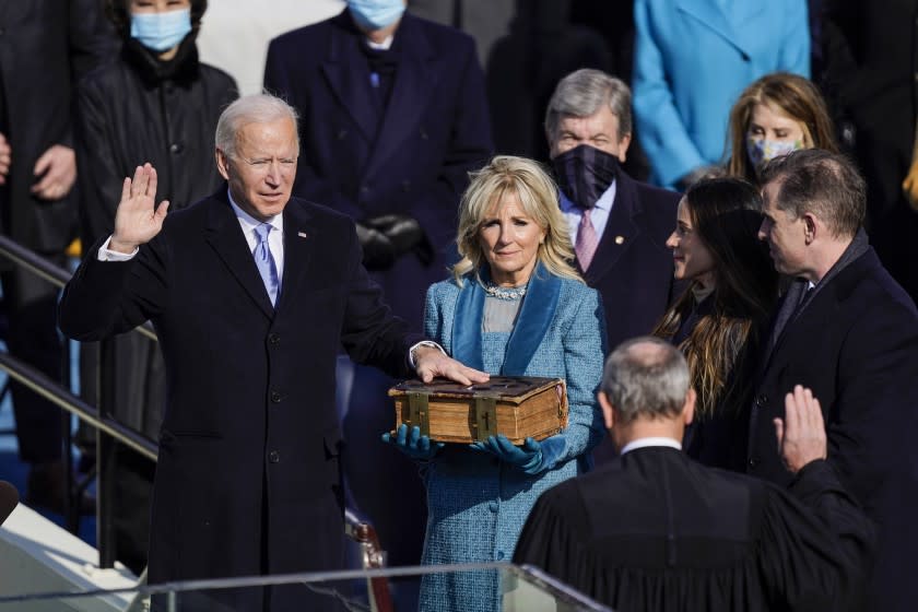 Washington , DC - January 20: U.S. President-elect Joe Biden takes the oath of office from Supreme Court Chief Justice John Roberts as his wife U.S. First Lady-elect Jill Biden stands next to him during the 59th presidential inauguration in Washington, D.C. on Wednesday, Jan. 20, 2021. . (Kent Nishimura / Los Angeles Times)
