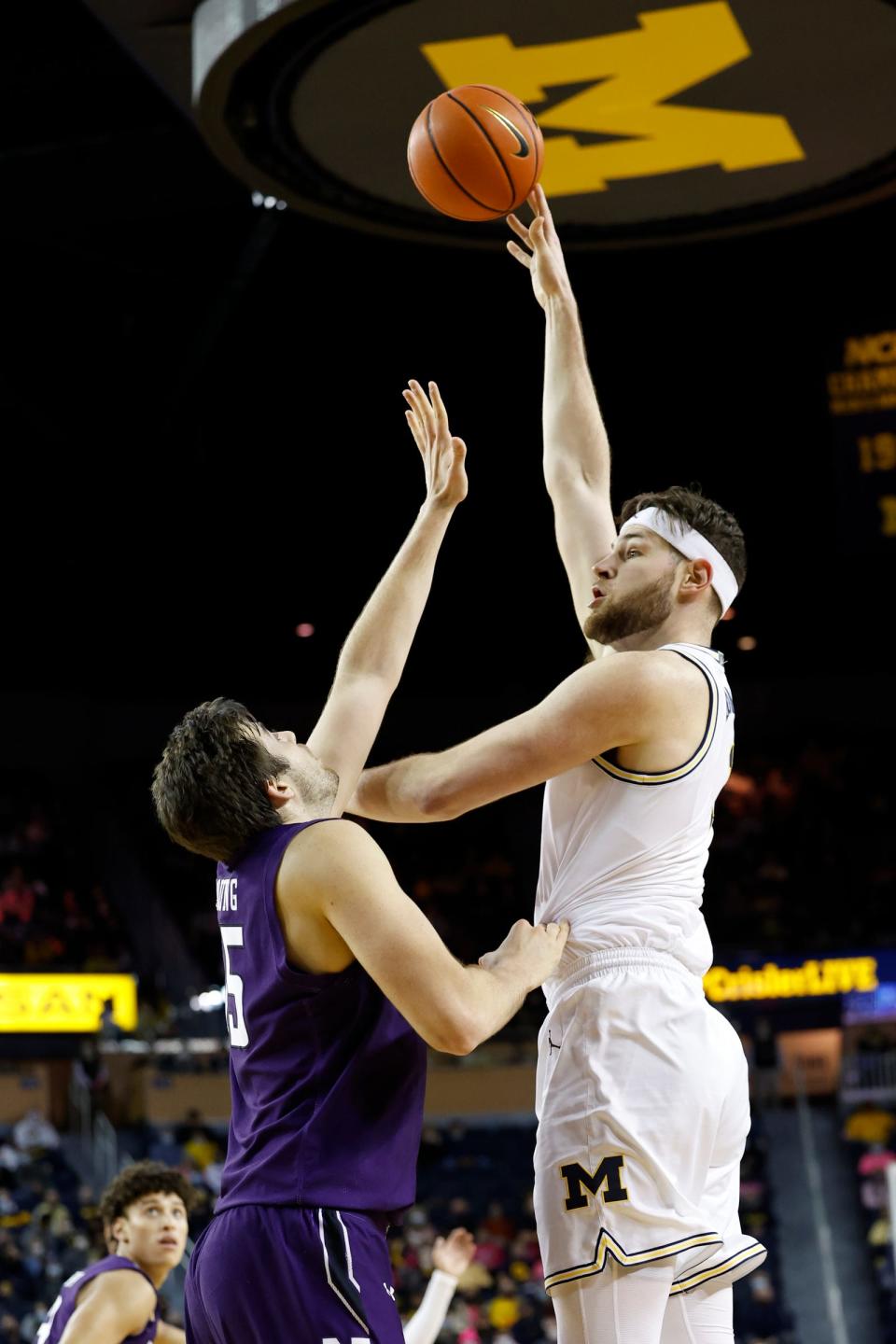 Michigan Wolverines center Hunter Dickinson (1) shoots against Northwestern Wildcats center Ryan Young (15) in the first half at Crisler Center on Jan. 26, 2022.