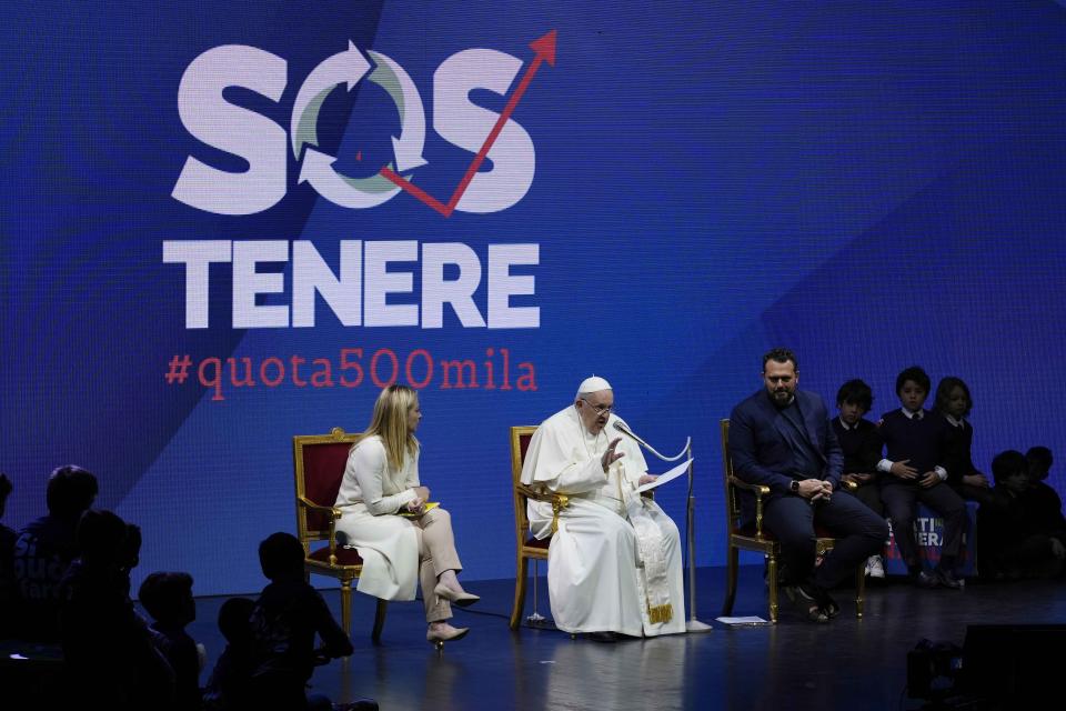 Pope Francis delivers his speech flanked by Italian Premier Giorgia Meloni during a conference on birthrate, at Auditorium della Conciliazione, in Rome, Friday, May 12, 2023. (AP Photo/Alessandra Tarantino)