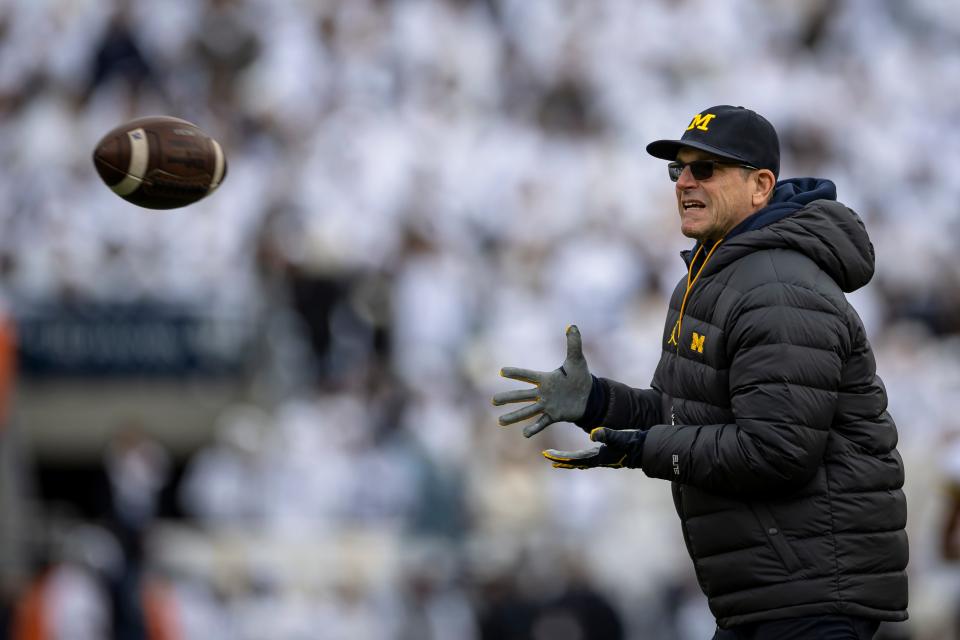 Michigan coach Jim Harbaugh warms up before the game against Penn State on Saturday, Nov. 13, 2021, in State College, Pennsylvania.