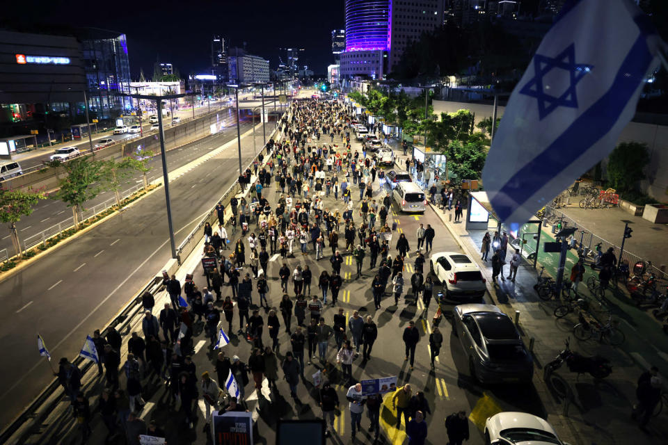 People March along a Tel Aviv boulevard in protest (Ahmad Gharabli / AFP via Getty Images)