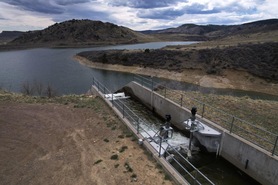 Water flows through an irrigation canal with a turbine at Ralston Reservoir in Arvada Colo. on Thursday, April 13, 2023. Emrgy, a business that places small turbines in irrigation canals to generate electricity, has raised $18.4 million to scale up its technology and generate carbon-free hydropower. (AP Photo/Brittany Peterson)