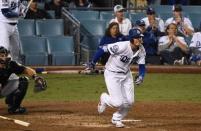 Oct 16, 2018; Los Angeles, CA, USA; Los Angeles Dodgers center fielder Cody Bellinger (35) hits an RBI single to defeat the Milwaukee Brewers in the thirteenth inning in game four of the 2018 NLCS playoff baseball series at Dodger Stadium. Mandatory Credit: Robert Hanashiro-USA TODAY Sports