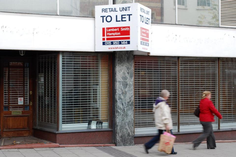 Pedestrians walking past an empty shop unit (PA) (PA Wire)