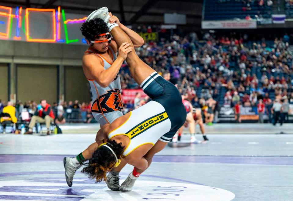 Lincoln Navarre Dixon is lifted and thrown onto the mat by Kennewick Jaden Lopez in 2023 at the Tacoma Dome. Lopez is returning this year.