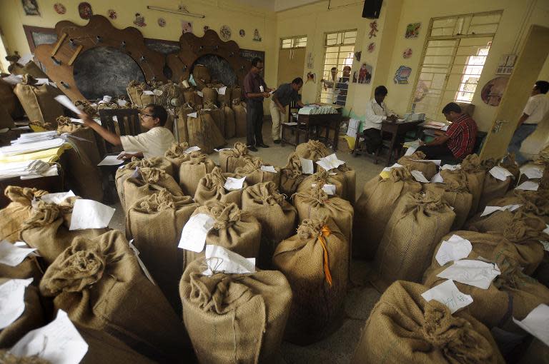 Indian election officials send sacks containing election materials during the distribution of Electronic Voting Machines to polling officials at Agartala, the capital of northeastern state of Tripura on April 6, 2014