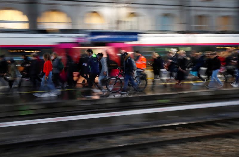 Commuters walk on a platform at Gare Saint-Lazare train station in Paris