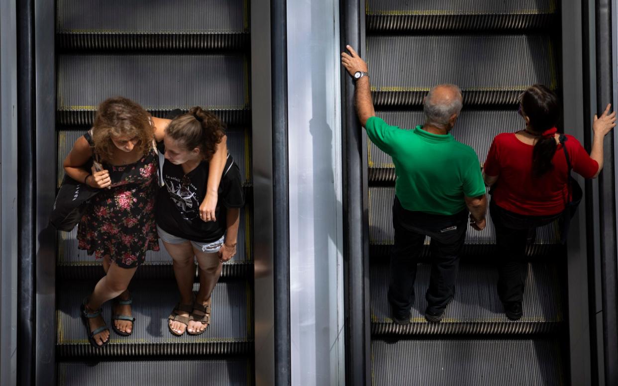 Israelis pack into malls without face masks after restrictions were lifted - Oded Balilty /AP