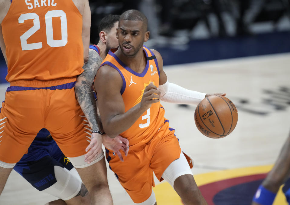 Phoenix Suns guard Chris Paul drives as Denver Nuggets guard Facundo Campazzo is slowed by screen by Suns forward Dario Saric during the first half of Game 3 of an NBA second-round playoff series Friday, June 11, 2021, in Denver. (AP Photo/David Zalubowski)