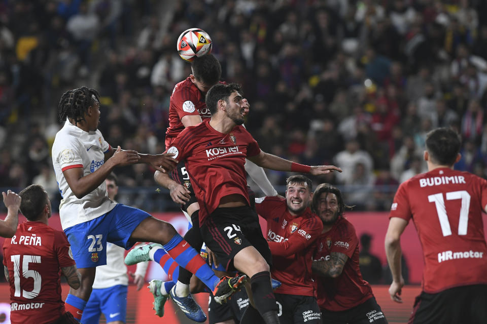 Osasuna's David Garcia jumps for the ball during the Spanish Super Cup semi final soccer match between Osasuna and Barcelona at Al Awal Park Stadium in Riyadh, Saudi Arabia, Thursday, Jan. 11, 2024. (AP Photo)