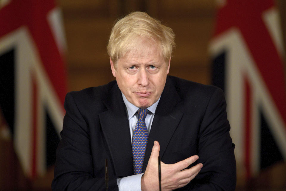 Britain's Prime Minister Boris Johnson speaks, during a coronavirus media briefing in Downing Street, London, Tuesday, Oct. 20, 2020. British Prime Minister Boris Johnson says he is imposing the highest level of coronavirus restrictions on the Greater Manchester region, after days-long negotiations between his government and local leaders who reject the measures broke down with no deal reached. (Leon Neal/Pool Photo via AP)