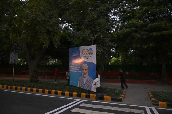 Workers install a billboard with a portrait of India' Prime Minister Narendra Modi ahead of the G20 summit in New Delhi on Sept. 8. <span class="copyright">Tauseef Mustafa—AFP/Getty Images</span>