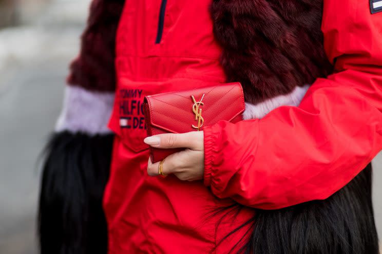 Designer bags like this popular Yves Saint Laurent clutch are sold at a steep discount on resale sites. (Photo: Getty Images)