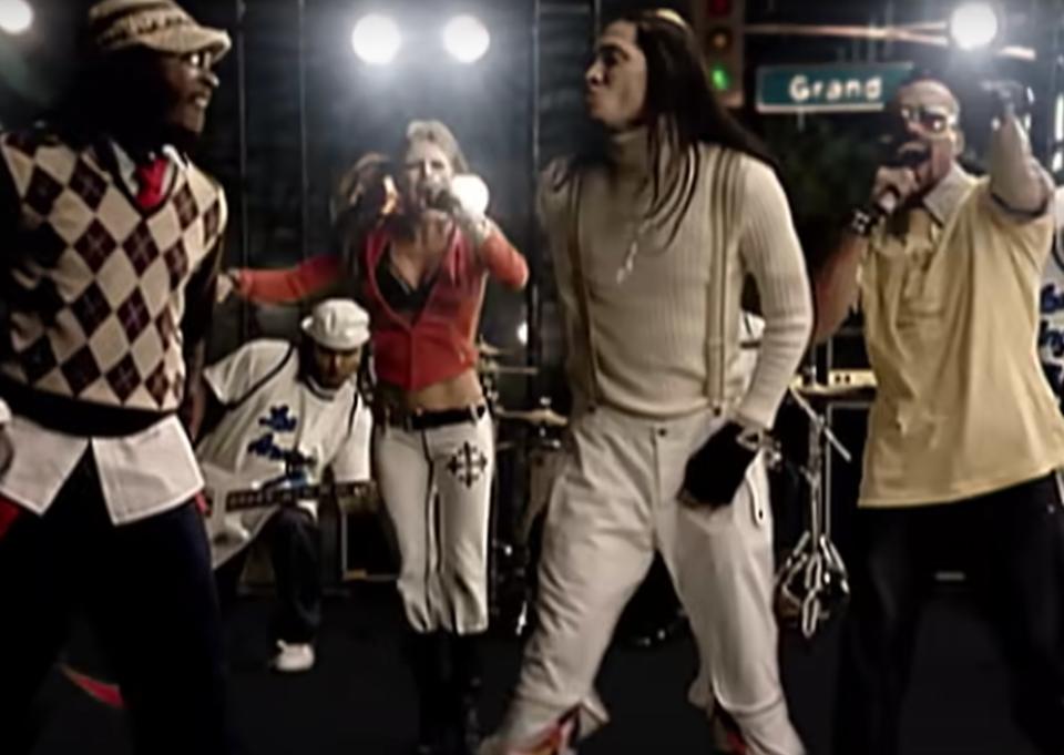 Members of the Black Eyed Peas sing and dance for fans in the street in the "Let's Get It Started" video