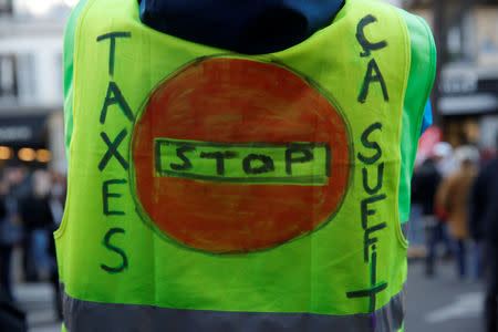 A protester wears a yellow vest at a CGT labour union demonstration to protest against the French government's reforms in Paris, France, December 14, 2018. REUTERS/Gonzalo Fuentes