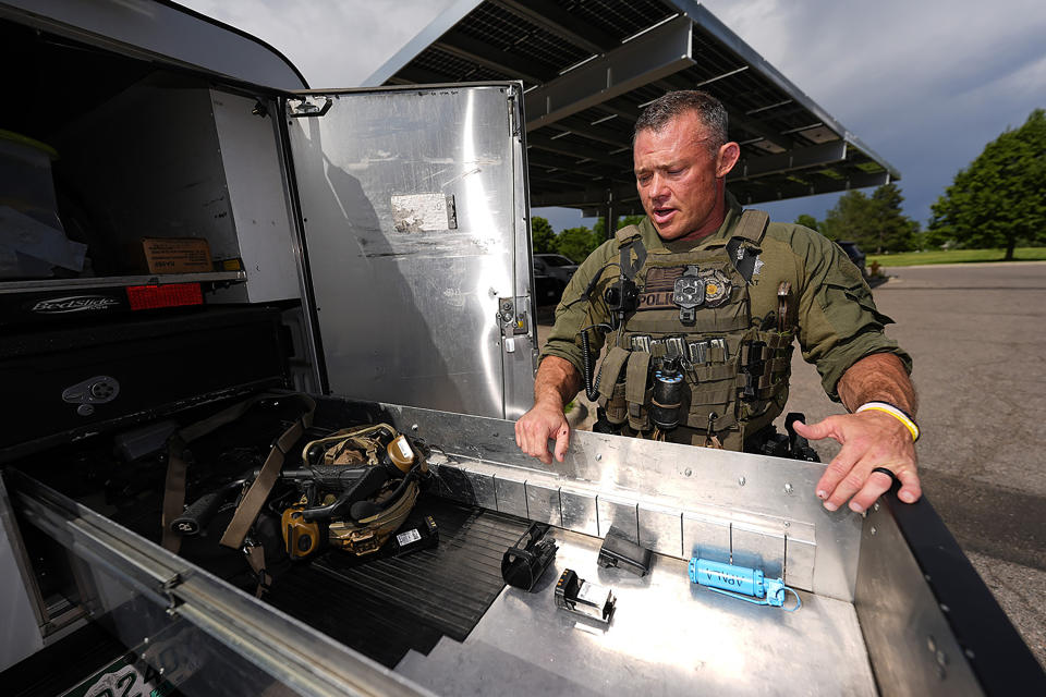 Denver Police Department Sgt. Justin Dodge surveys his gear Wednesday, June 12, 2024, in south Denver. Dodge lost his left leg below the knee when a firetruck carrying members of the NBA champion Denver Nuggets during a parade rolled over the officer's left ankle. (AP Photo/David Zalubowski)