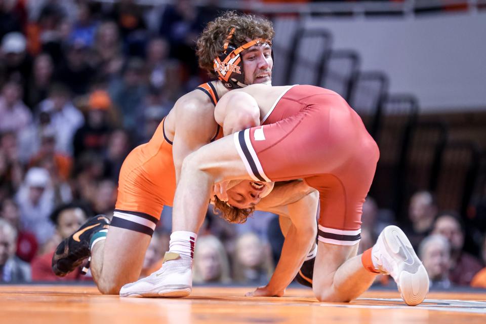 Oklahoma State’s Daton Fix and Oklahomas Wyatt Henson fight for top position during a college wrestling meet between the Oklahoma State Cowboys (OSU) and the Oklahoma Sooners at Gallagher-Iba Arena in Stillwater, Okla., Thursday, Feb. 16, 2023.