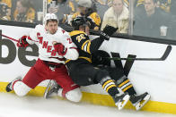 Carolina Hurricanes' Nino Niederreiter, of Switzerland, left, slams Boston Bruins' Curtis Lazar, right, into the boards in the third period of Game 4 of an NHL hockey Stanley Cup first-round playoff series, Sunday, May 8, 2022, in Boston. The Bruins won 5-2. (AP Photo/Steven Senne)
