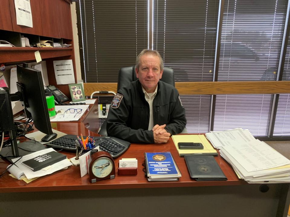 Retired Abilene police Detective David Atkins sits at his desk in the Taylor County Sheriff's Office where he is continuing his law-enforcement career as a lieutenant.
