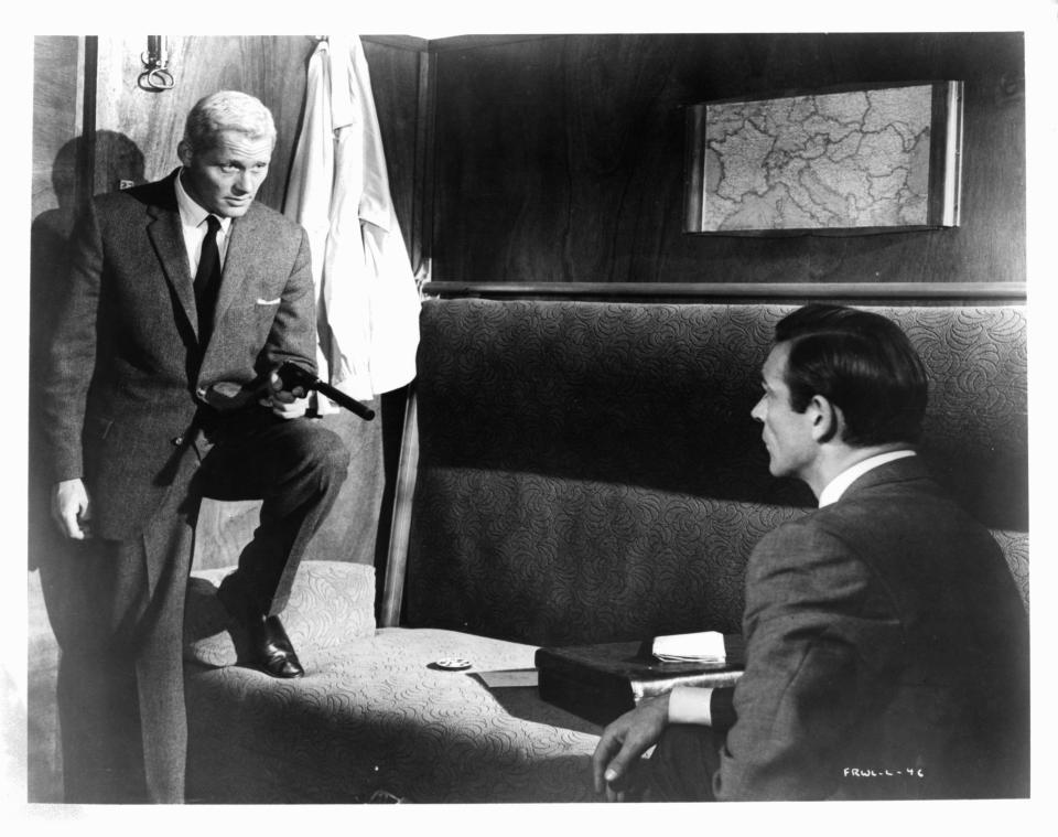 Robert Shaw aiming a gun at Sean Connery in a scene from the film 'James Bond: From Russia With Love', 1963. (Photo by United Artist/Getty Images)