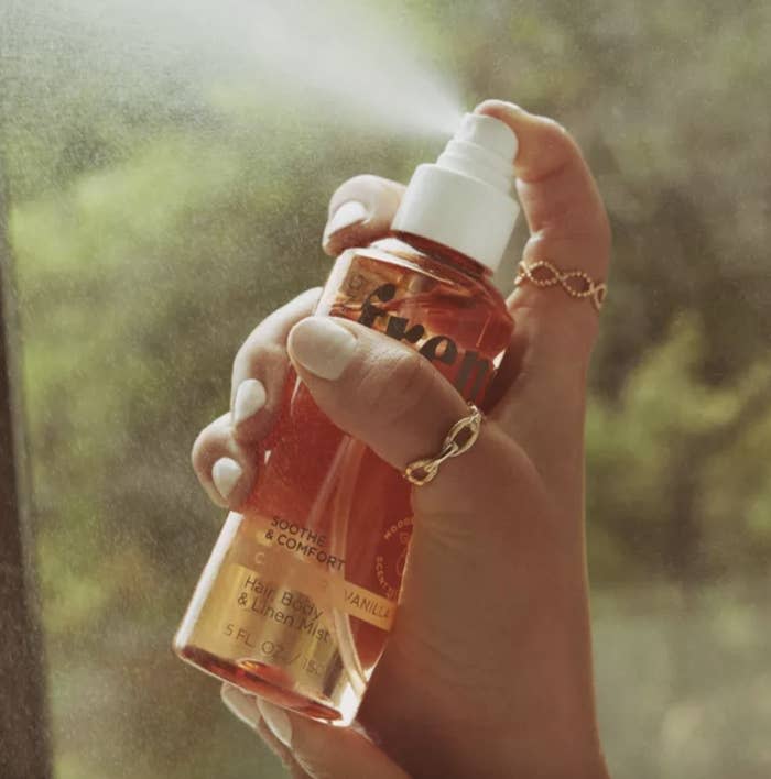 a spray bottle in a hand being sprayed