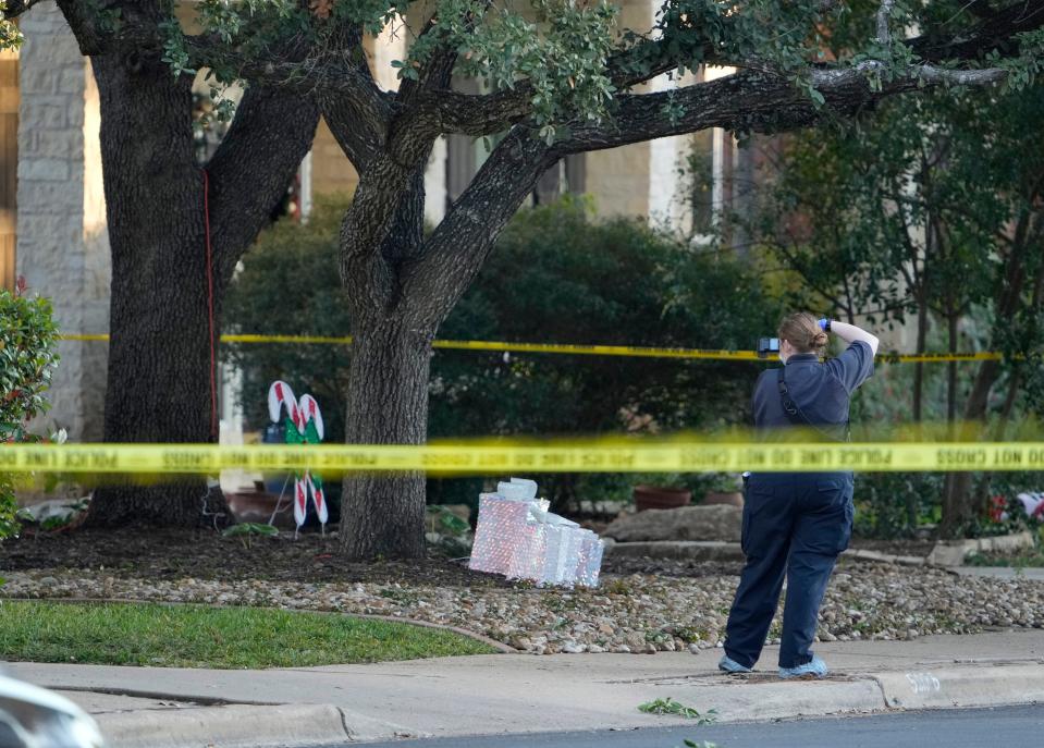 A crime scene investigator works Wednesday at the scene of Tuesday's fatal shootings on Austral Loop in Southwest Austin.