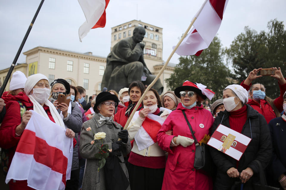 People, most of them pensioners, hold old Belarusian national flags march during an opposition rally to protest the official presidential election results in Minsk, Russia, Monday, Oct. 26, 2020. Factory workers, students and business owners in Belarus have started a general strike, calling for authoritarian President Alexander Lukashenko to resign after more than two months of mass protests triggered by a disputed election. (AP Photo)