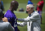 In this June 18, 2015, photo, Former Minnesota Vikings coach Jerry Burns greets Adrian Peterson after practice at the NFL football team's minicamp in Eden Prairie, Minn. Burns, the colorful character who took over as the Vikings' head coach in a time of turmoil and led the team to three playoff berths, has died. He was 94. The team announced Burns’ death. Vikings spokesman Bob Hagan said Burns’ son-in-law informed him of Burns’ death Wednesday morning, May 12, 2021. (Brian Peterson/Star Tribune via AP)