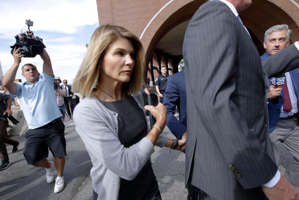 In this Aug. 27, 2019 file photo, actress Lori Loughlin departs federal court in Boston after a hearing in a nationwide college admissions bribery scandal.  Loughlin, her fashion designer husband, Mossimo Giannulli, and nine other parents face new charges in the college admissions scandal. Federal prosecutors announced Tuesday, Oct. 22, 2019, that the parents were indicted on charges of conspiracy to commit federal program bribery.