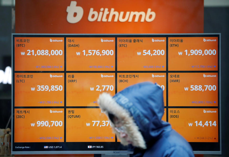 A man walks past an electric board showing exchange rates of various cryptocurrencies at Bithumb cryptocurrencies exchange in Seoul, South Korea, January 11, 2018.  REUTERS/Kim Hong-Ji