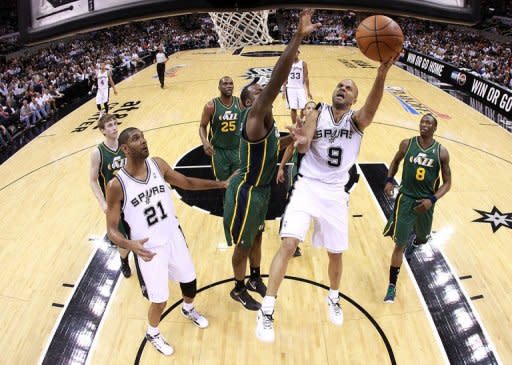 Tony Parker (2nd R) of the San Antonio Spurs takes a shot as Utah Jazz's Paul Millsap during game two of the NBA Western Conference first-round playoff series on May 2. Parker scored 18 points and handed out nine assists for the Spurs