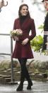 <p>The Duchess of Cambridge wears a maroon Paule Ka skirt suit, black tights, gloves and knee-high boots by Stuart Weitzman during a visit to Wales.</p>