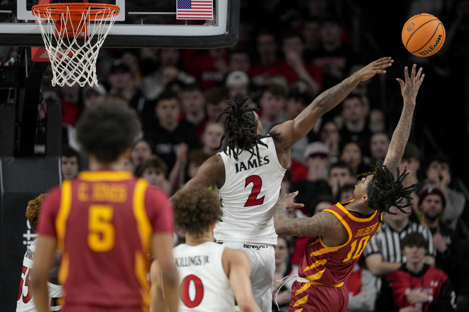 Cincinnati's Jizzle James (2) blocks a shot by Iowa State's Keshon Gilbert during the first half of an NCAA college basketball game, Tuesday, Feb. 13, 2024, in Cincinnati. (AP Photo/Jeff Dean)