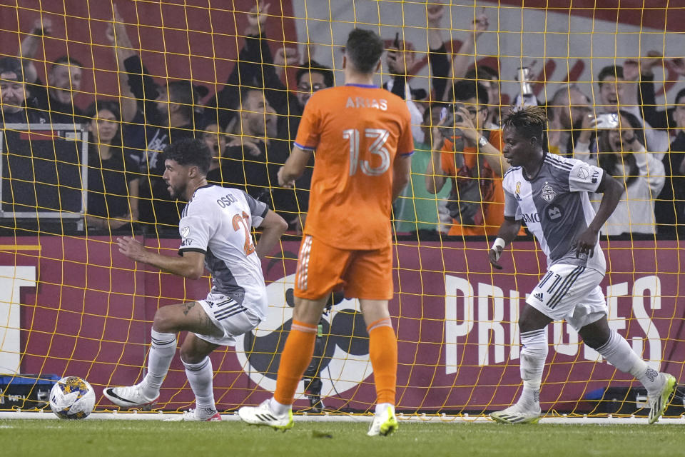 Toronto FC's Jonathan Osorio, left, turns to celebrate after scoring against FC Cincinnati during the first half of an MLS soccer match Saturday, Sept. 30, 2023, in Toronto. (Chris Young/The Canadian Press via AP)