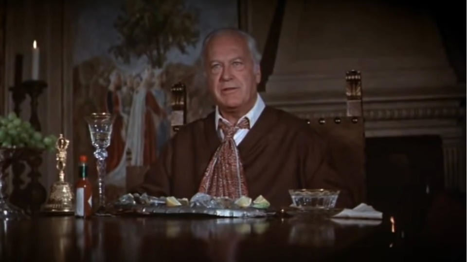 Curt Jurgens sits in conversation at a dining table in The Spy Who Loved Me.
