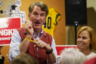 Virginia Republican gubernatorial candidate Glenn Youngkin displays a wristband as greets supporters during a meet and greet at a sports bar in Chesapeake, Va., Monday, Oct. 11, 2021. Youngkin faces former Governor Terry McAuliffe in the November election. (AP Photo/Steve Helber)