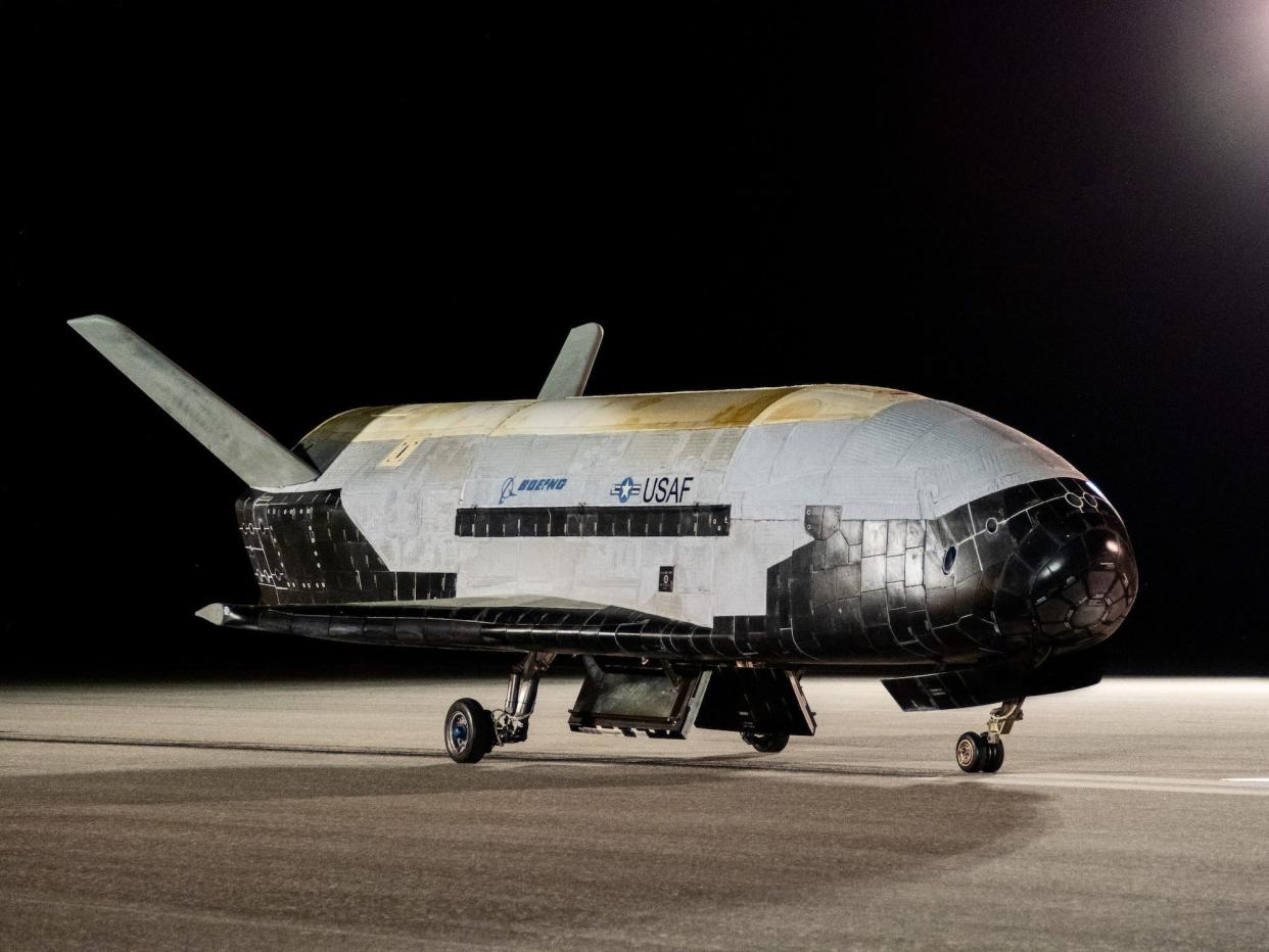 small white and black space plane on a runway