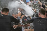 Detroit Tigers starting pitcher Spencer Turnbull (56) is showered with beer and powder by teammates after Turnbull threw a no-hitter in the team's baseball game against the Seattle Mariners, Tuesday, May 18, 2021, in Seattle. The Tigers won 5-0. (AP Photo/Ted S. Warren)