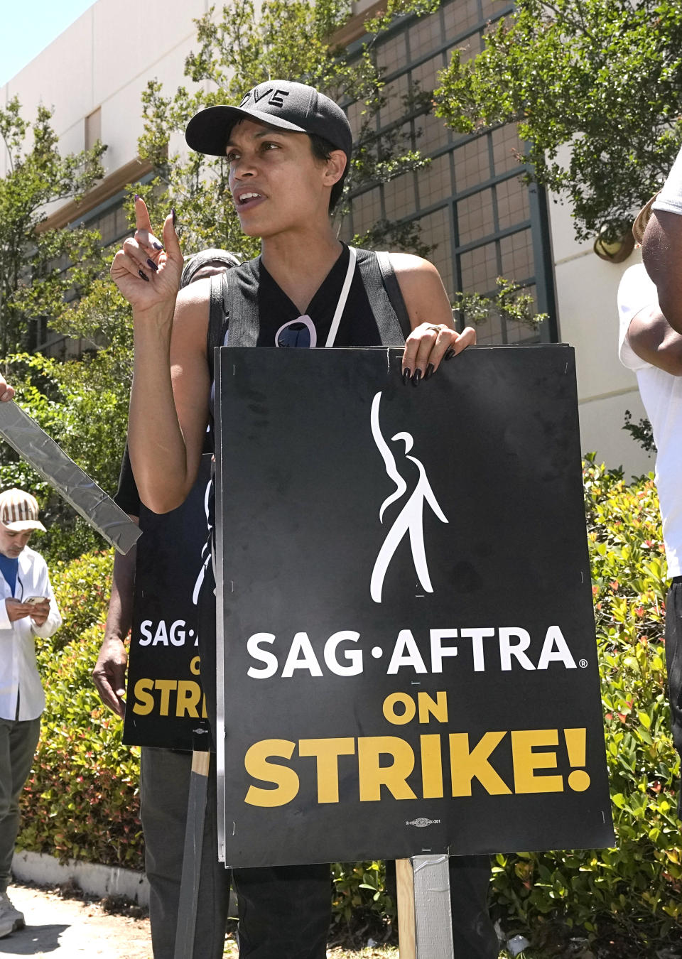 Actor Rosario Dawson attends a rally by striking writers and actors outside Warner Bros. studios in Burbank, Calif. on Friday, July 14, 2023. This marks the first day actors formally joined the picket lines, more than two months after screenwriters began striking in their bid to get better pay and working conditions and have clear guidelines around the use of AI in film and television productions.(AP Photo/Mark J. Terrill)