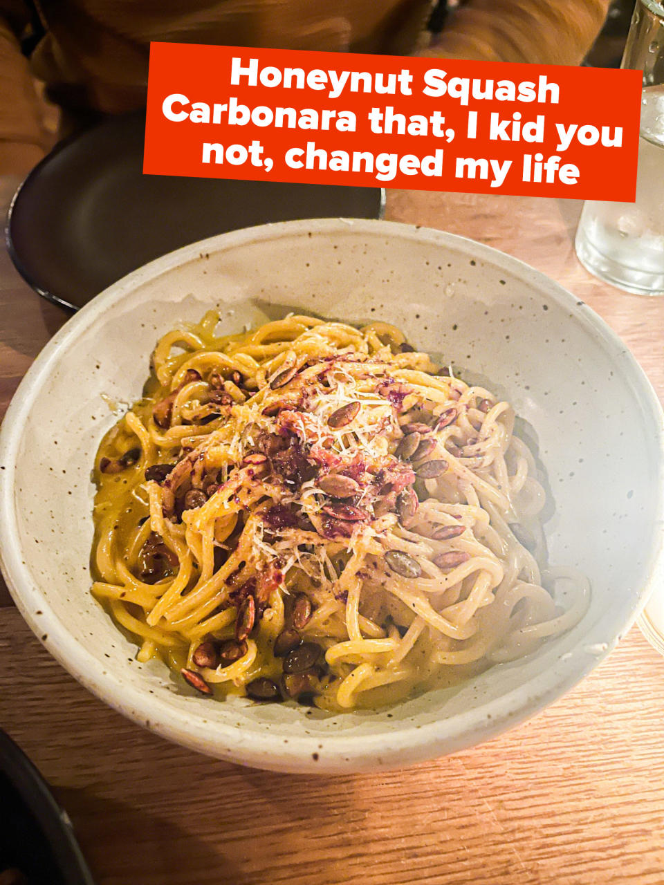 A bowl of carbonara with the text "Honeynut Squash Carbonara that, I kid you not, changed my life"