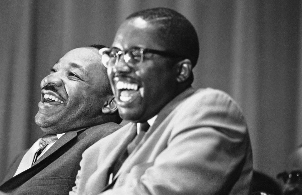 Civil rights leader Martin Luther King Jr., left, and Tuskegee attorney Fred Gray break into laughter at a joke told by a speaker at a political rally in Tuskegee, Alabama, April 29, 1966. Rev. King is on a whistle-stop tour through Alabama to encourage block-voting by blacks in the May 3 Alabama primary. Gray is a candidate for a seat in the Alabama House of Representatives. (AP Photo/Jack Thornell)