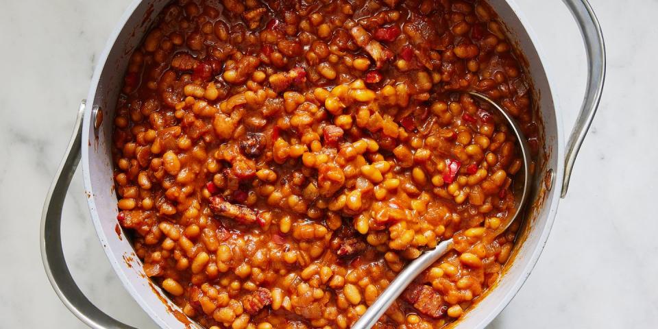 saucy baked beans scooped out of a pot