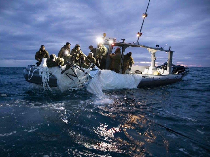 Sailors assigned to Explosive Ordnance Disposal Group 2 recover a high-altitude surveillance balloon off the coast of Myrtle Beach, South Carolina, Feb. 5, 2023.