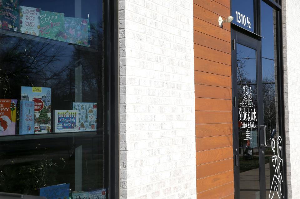 Sidekick Coffee & Books’ logo and window display pictured Monday, Dec. 18, 2023 in Iowa City, Iowa.