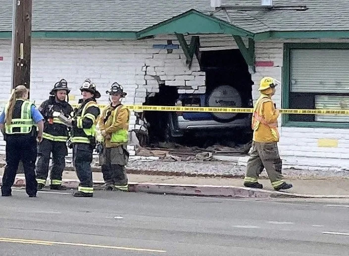 Firefighters stand in front of the Great Adventures Christian Preschool and Daycare in Anderson where a woman crashed her vehicle into the day-care center around 2:30 p.m. March 3, 2022.