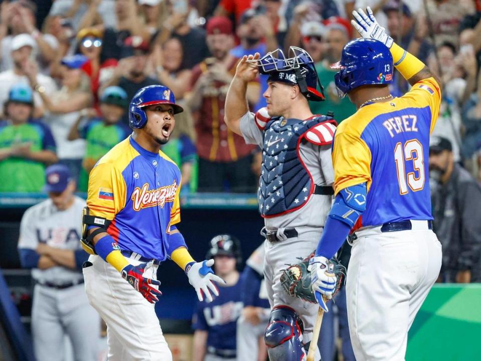 Venezuela’s Luis Arraez (2) homers on a fly ball to right field as Jose Altuve (27) scores as USA catcher J.T. Realmuto (10) looks on in the first inning during the World Baseball Classic quarterfinal at loanDepot Park in Miami on Saturday, March 18, 2023.