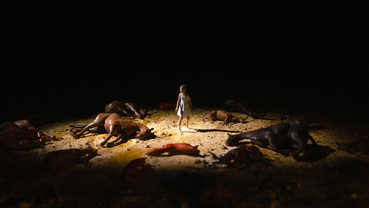  A screenshot from a WWF animation showing a girl surrounded by dead animals, all 3D printed. 