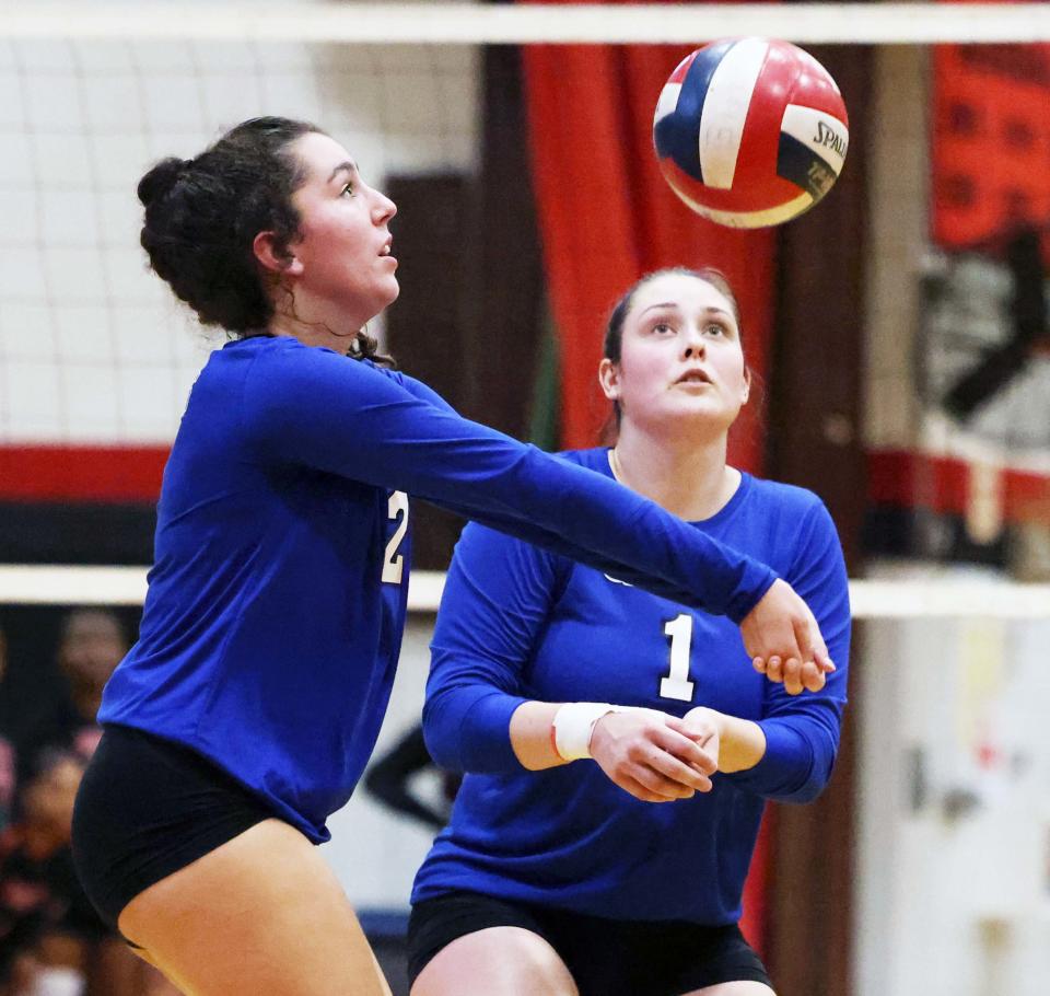 From left, Quincy's Sarah Kabay sets the volleyball for teammate Annika Schmitt during a game versus Brockton on Wednesday, Sept. 7, 2022. 