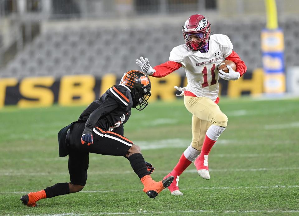 Serra Catholic's Jayvon Holt attempts to escape Beaver Falls' Trey Singleton during the WPIAL Class 2A championship game, Friday at Heinz Field.