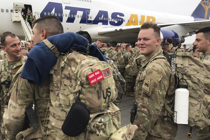 Soldiers from the 1st Armored Division, based in Fort Bliss, Texas, arrives at the airport Tegel in Berlin, Thursday, March 21, 2019. Over three hundred soldiers have arrived in Germany from their base in Texas in the first test of a new American strategy to rapidly deploy troops based in the United States to Europe to bolster the NATO deterrent against possible Russian aggression. (AP Photo/Dorothee Thiesing)
